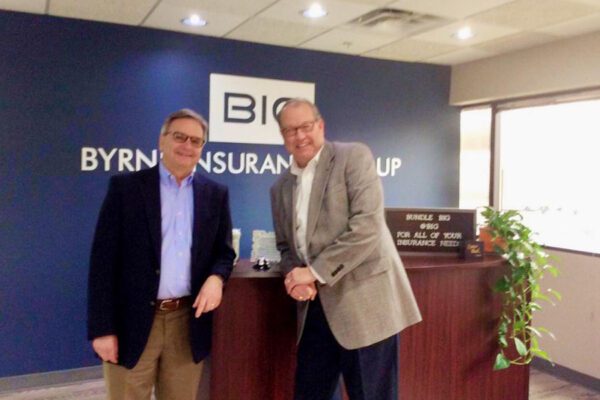 About Our Agency - Portrait of Byrne Insurance Group Agency Owners in the Office Reception Desk